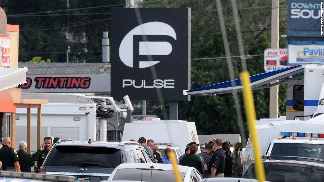 Police officers gather outside of the nightclub, which describes itself as &quot;the hottest gay bar&quot; in the heart of Orlando.