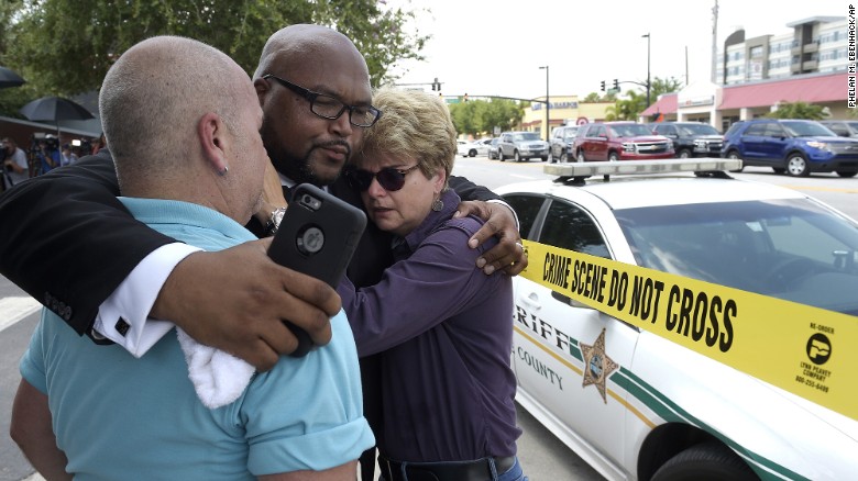 Church pastor Kelvin Cobaris hugs Orlando City Commissioner Patty Sheehan and Terry DeCarlo, executive director of the LGBT Center of Central Florida, after a shooting at the Pulse nightclub killed at least 50 people and injured at least 53 on Sunday, June 12. Orlando police said they shot and killed the gunman.
