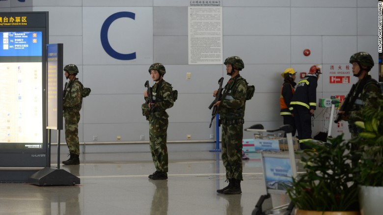 Armed troops inside Pudong airport seal off part of the arrivals terminal.