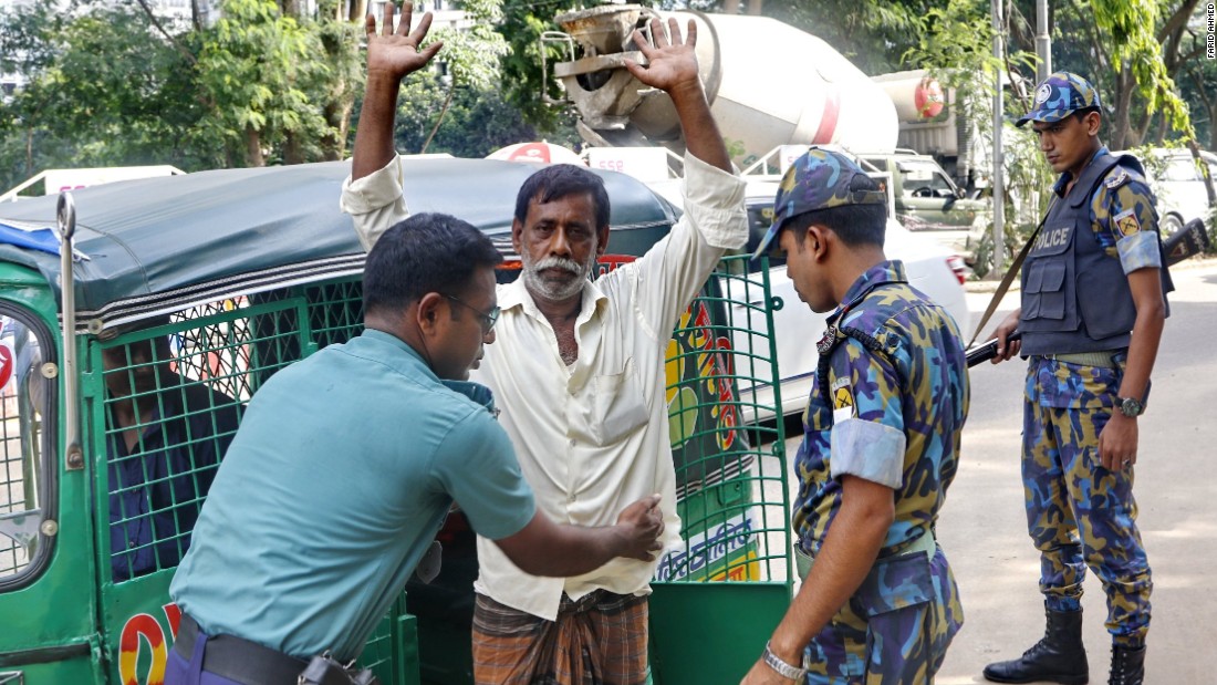 A man is frisked by Bangladesh police on June 10, 2016. 