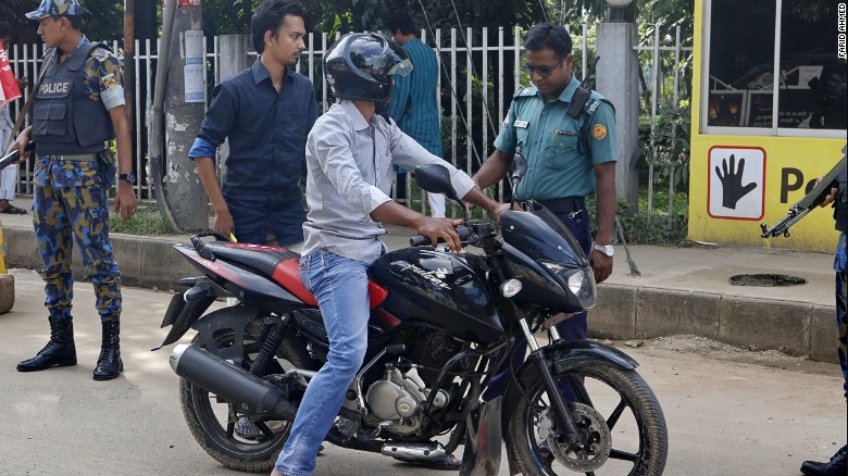 A man on a motorcycle is stopped at a police check-post in Gulshan in the capital of Dhaka. 