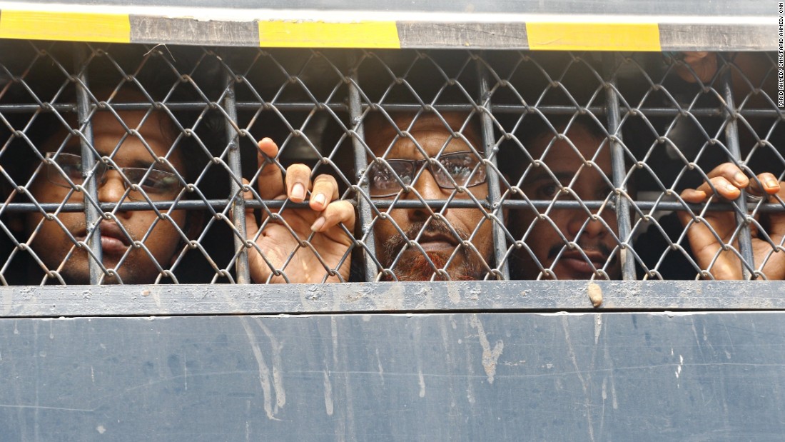 Detained Bangladeshis in a police van prison van as they are taken to the Dhaka Magistracy in Dhaka.