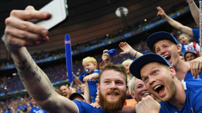  Aron Gunnarsson of Iceland takes a selfie photographs with Iceland fans.
