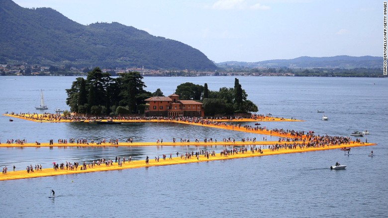 The Floating Piers -- a new free installation by artist Christo -- lets the public walk between the mainland and the lake&#39;s two islands. 