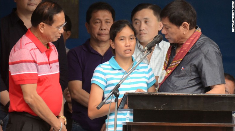 Duterte talks to released hostage Marites Flor on stage, June 24, 2016. 