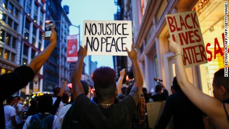 People shout slogans during a protest in support of the Black lives matter movement in New York on July 09, 2016. 
The gunman behind a sniper-style attack in Dallas was an Army veteran and loner driven to exact revenge on white officers after the recent deaths of two black men at the hands of police, authorities have said. Micah Johnson, 25, had no criminal history, Dallas police said in a statement. / AFP / KENA BETANCUR        (Photo credit should read KENA BETANCUR/AFP/Getty Images)