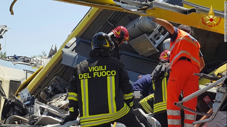 Italian firefighters inspect the wreckage of two trains after a head-on collision in the southern region of Puglia on Tuesday.