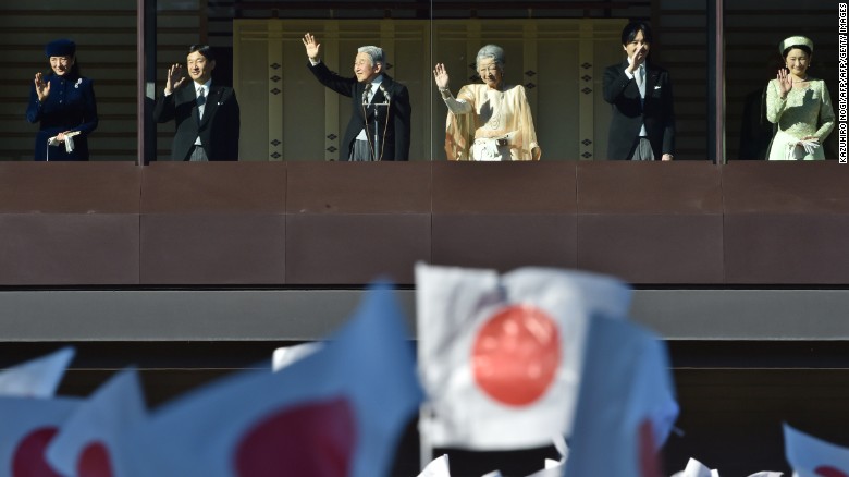 From the balcony of the Imperial Palace, Emperor Akihito greets thousands of people, waving Japanese flags, who have gathered to wish him a happy 82nd birthday on December 23, 2014.