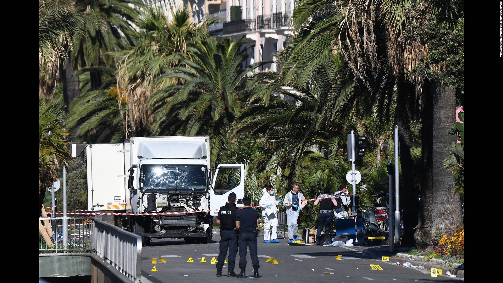 Forensics officers and policemen look for evidences near a truck on the Promenade des Anglais seafront in the French Riviera town of Nice on July 15, 2016, after it drove into a crowd watching a fireworks display.
An attack in Nice where a man rammed a truck into a crowd of people left 84 dead and another 18 in a "critical condition", interior ministry spokesman Pierre-Henry Brandet said Friday. An unidentified gunman barrelled the truck two kilometres (1.3 miles) through a crowd that had been enjoying a fireworks display for France's national day before being shot dead by police.
/ AFP / ANNE-CHRISTINE POUJOULAT (Photo credit should read ANNE-CHRISTINE POUJOULAT/AFP/Getty Images)