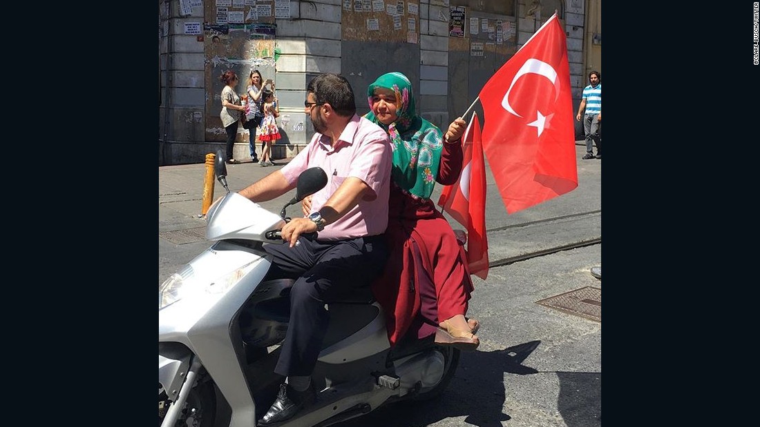 A scooter joins demonstratord headed toward Taksim Square.
