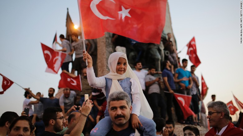 People wave flags in Istanbul&#39;s Taksim Square on Saturday in support of  President Recep Tayyip Erdogan. 