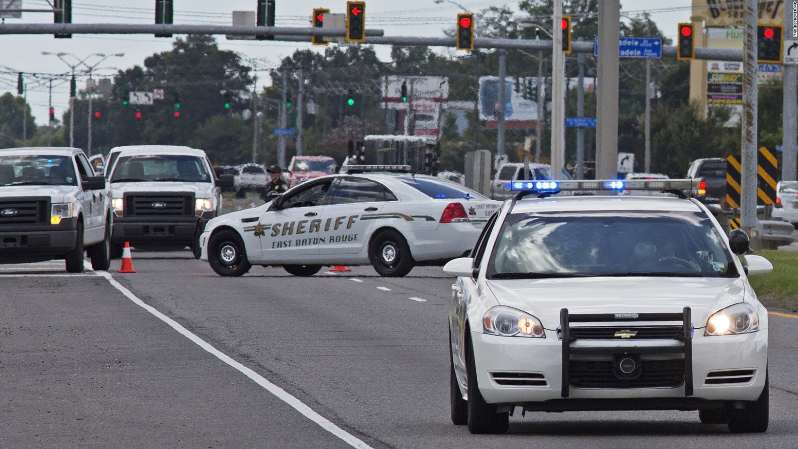 Baton Rouge Police arrive at the scene on Airline Highway after police were shot in Baton Rouge, La., Sunday, July 17, 2016. At least three officers are confirmed dead and at least three others wounded after the shooting, a sheriff's office spokeswoman said Sunday. One suspect is dead and law enforcement officials believe two others are still at large, the spokeswoman said.
(AP Photo/Max Becherer)