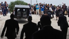 The casket of Alton Sterling is driven away after his funeral.