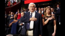 Former House Speaker Newt Gingrich stands during the national anthem on Monday.