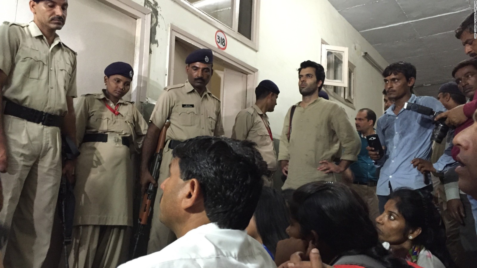 Security doesn't stop protesters from entering a hospital where a woman is treated in an alleged rape.