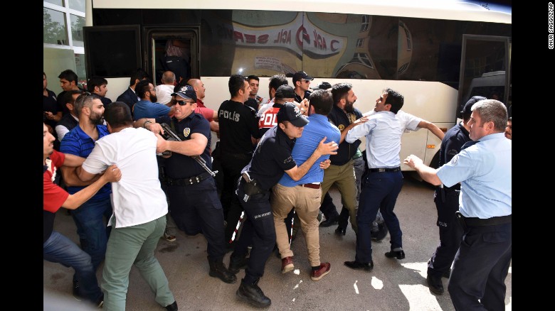 Police try to stop people from attacking a judge, suspected in the failed coup plot, in Erzurum, Turkey on Tuesday, July 19. Turkey has fired or suspended about 50,000 people as the government intensifies a crackdown following last weekend&#39;s failed coup attempt. Teachers, journalists, police and judges have been affected. 