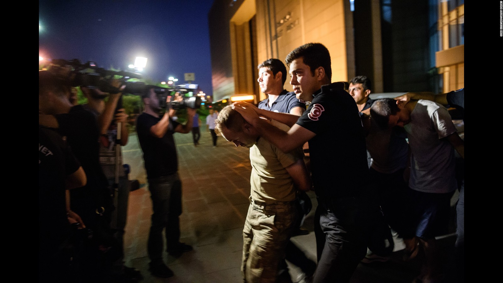 Turkish anti-riot police officers in Istanbul escort soldiers accused of taking party in a military coup that failed over the weekend.