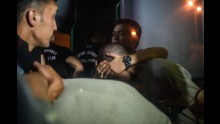 Turkish police officers cover the eyes of soldiers as they are transported in a bus from the courthouse in Istanbul on July 16.