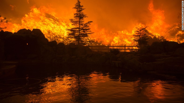 Flames from the Sand fire are reflected in a backyard swimming pool on Saturday, July 23, in Santa Clarita, California. As of Saturday night the fire had swelled to 20,000 acres and hundreds of residents were being ordered to evacuate their homes, fire officials said.&lt;br /&gt;