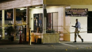 An investigator walks near the scene of the fatal shooting.