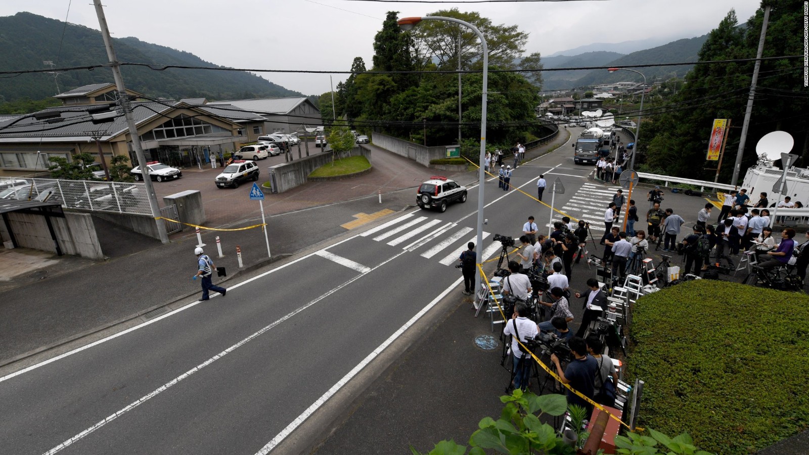 Journalists gather across the street from the Tsukui Yamayuri En care centre.