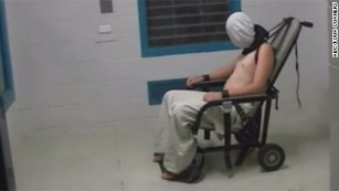 The &quot;Four Corners&quot; program reported that this image shows Dylan Voller, then 17, in a white hood, shackled at the neck with his arms strapped to a chair at a detention center in Alice Springs, Australia.
