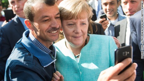 Merkel slams attacks, but stands by migrant policy