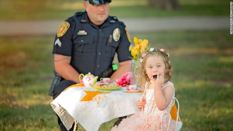 Officer joins little girl he saved in a tea party