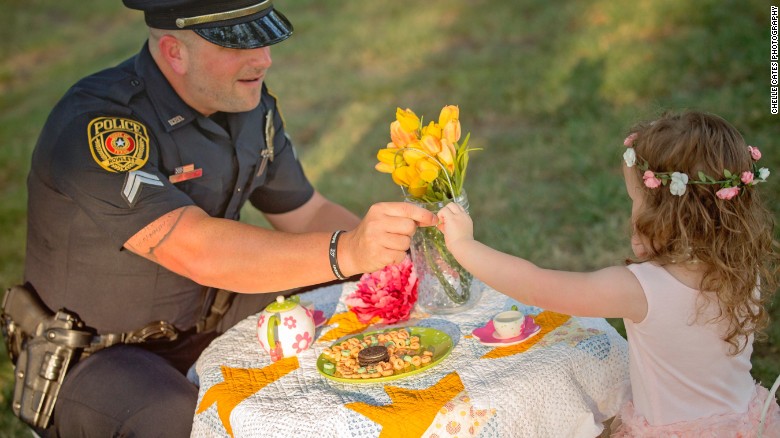 Officer joins little girl he saved in a tea party