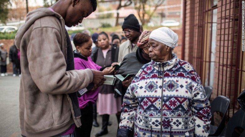 South African voters show their IDs before voting Wednesday in municipal elections in Johannesburg.