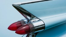 Horizontal color detail photograph of the rear fin and tail light of a 1959 Cadillac Series 62 Convertable with Breton blue paint. Photographed at the 2016 Greenwich Concours d'Elegance. Greewich, CT.