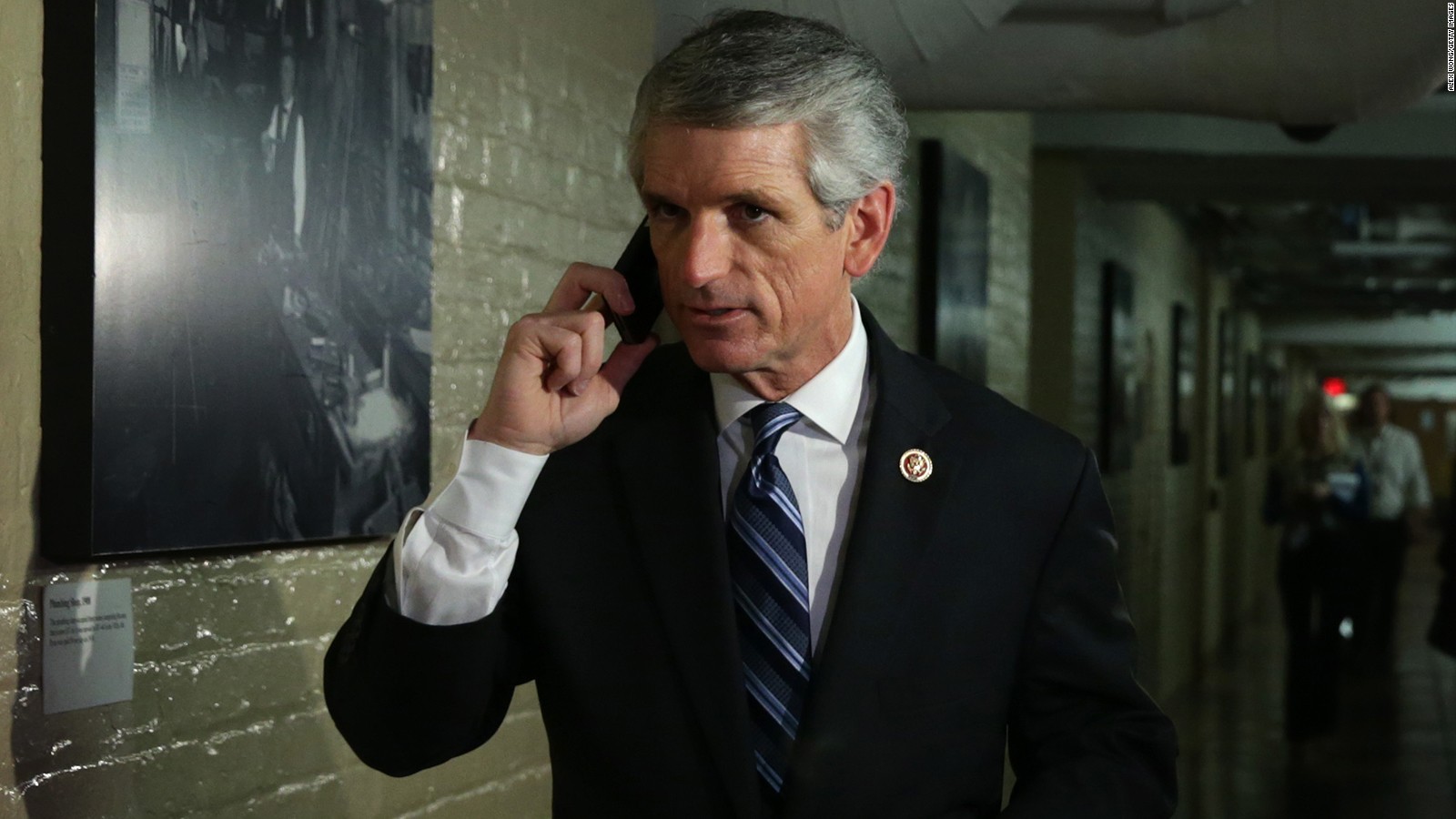 Rep. Scott Rigell (R-VA) talks on his phone as he arrives at a House Republican Conference meeting September 28, 2013 on Capitol Hill in Washington, DC.