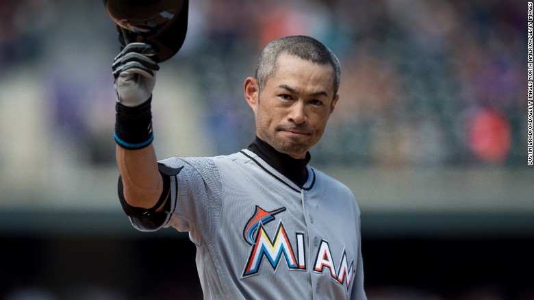 Ichiro Suzuki of the Miami Marlins tips his hat to the crowd after hitting a seventh inning triple against the Colorado Rockies for the 3,000th hit of his MLB career.