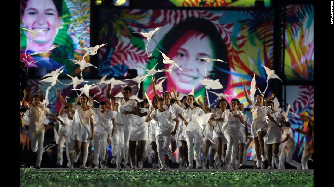 Children fly kites during the opening ceremony on Friday, August 5.