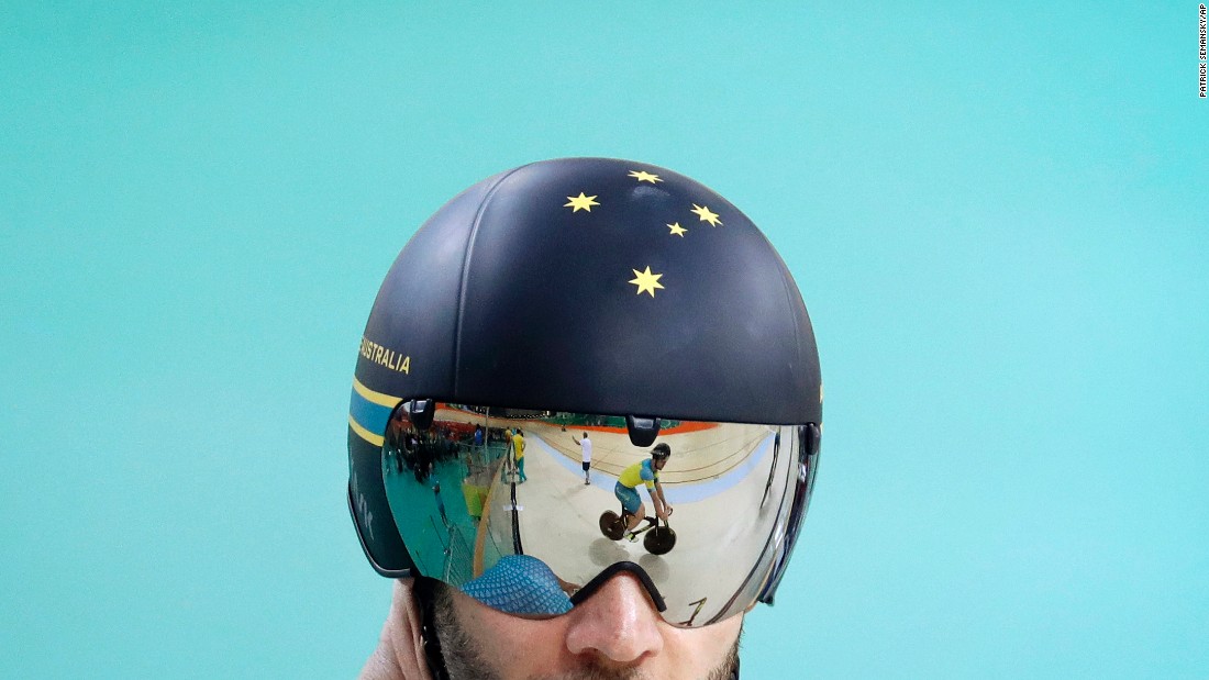 An Australian cyclist is reflected on a teammate's visor during a training session on Thursday, August 4.