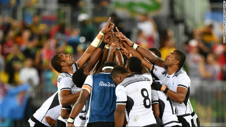 Fiji&#39;s players pray after victory in the men&#39;s rugby sevens gold medal match.