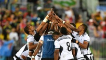 Fiji's players pray after victory in the men's rugby sevens gold medal match between Fiji and Britain.