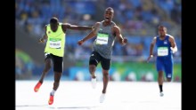 Mohammed Abukhousa of Palestine, center, and Holder da Silva of Guinea-Bissau compete in the men's 100m preliminary round.