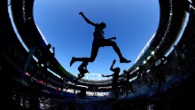 Athletes clear the water jump in round 1 of the women's 3000m steeplechase.