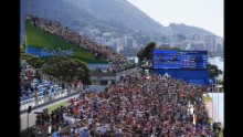 Fans watch the men's single sculls final in the rowing competition.