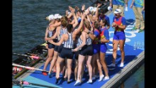 Team USA celebrates winning the gold medal with members of Romania who won the bronze in the women's eight competition.