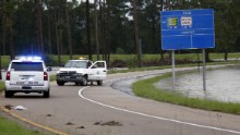Officials close down an exit off Interstate 55 south in Independence as floodwaters creep closer to the highway on August 13.