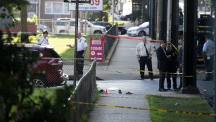 Sandals remain on a New York sidewalk following shooting.