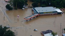 Floodwaters overwhelm businesses in Hammond on August 13.