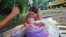 Danielle Blount and her 3-month-old baby, Ember, wait to be rescued by the Louisiana Army National Guard near Walker, Louisiana, on Monday, August 15. 