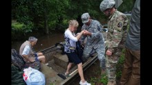Members of the Louisiana Army National Guard help people near Walker on August 15.