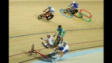 Elia Viviani of Italy, Glenn O'Shea of Australia and Sanghoon Park of Korea crash during the Cycling Track Men's Omnium Points Race