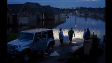 Residents evacuate Hammond, Louisiana, with food in ice chests on Saturday, August 13.