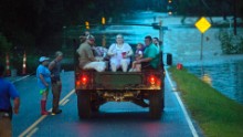 Emergency personnel rescue flood victims near Walker on August 14.