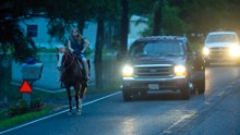 A girl takes her horse out on a dry road near Walker on August 14.